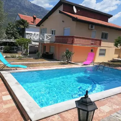a large swimming pool in front of a house at Vila Šeki in Bar