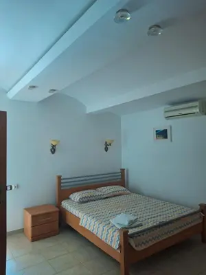 a bedroom with a bed and a white ceiling at Vila Šeki in Bar