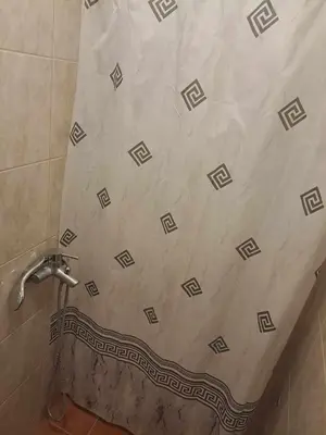 a shower in a bathroom with a tiled floor at apartman ANAMI in Bar