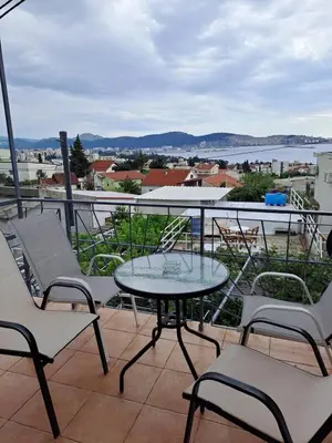 a patio with a table and chairs on a balcony at apartman ANAMI in Bar