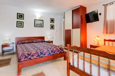 a bedroom with a bed and a tv on the wall at Sea Oasis Apartments - Milosevic in Kotor