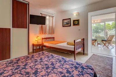 a bedroom with a bed and a sliding glass door at Sea Oasis Apartments - Milosevic in Kotor