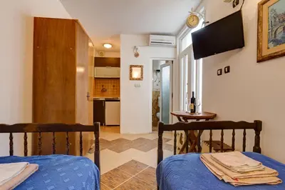 a living room with a bed and a kitchen at Sea Oasis Apartments - Milosevic in Kotor