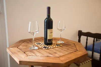 a bottle of wine sitting on a table with two wine glasses at Sea Oasis Apartments - Milosevic in Kotor