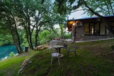 a house on a hill with a table and chairs at Rijeka Zeta, Podgorica in Podgorica