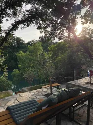 a bench sitting on top of a stone patio at Rijeka Zeta, Podgorica in Podgorica