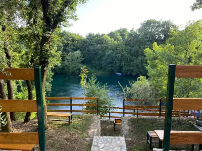a group of benches sitting next to a river at Rijeka Zeta, Podgorica in Podgorica