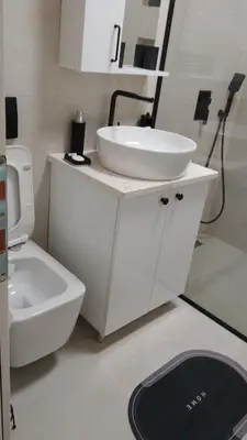 a white bathroom with a sink and a toilet at Vila HELENA in Dobra Voda