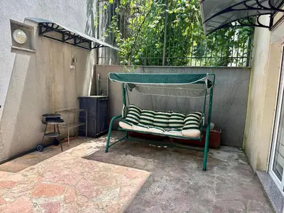a green bed with striped pillows on it at Apartments Comfort Petrovac in Petrovac na Moru