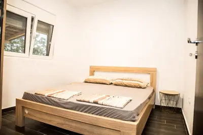 a bedroom with a bed in a room with a window at Village house Katarina in Cetinje