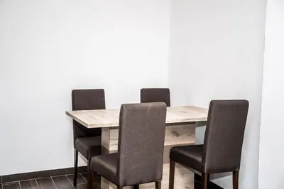 a dining room table with four chairs around it at Village house Katarina in Cetinje