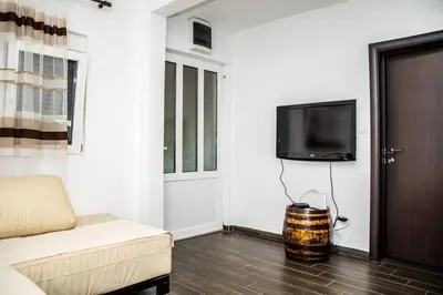 a living room with a couch and a flat screen tv at Village house Katarina in Cetinje
