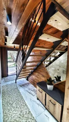a room with a wooden staircase with a wooden ceiling at Coratina Cottage in Ulcinj