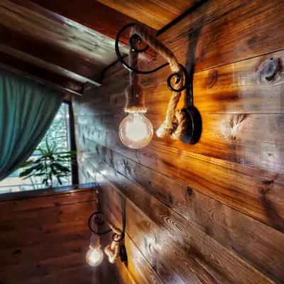 a room with a wooden wall with lights on it at Coratina Cottage in Ulcinj