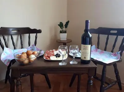 a table with a bottle of wine and two glasses at B&B Ana in Virpazar