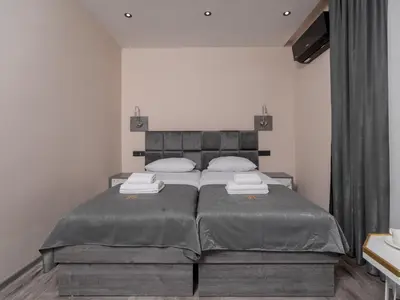 a bedroom with a large bed with two pillows at Hotel Diman in Dobra Voda