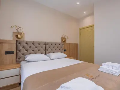 a bedroom with a large bed with two white pillows at Hotel Diman in Dobra Voda