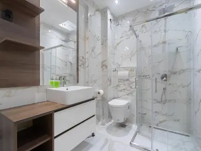 a bathroom with a sink toilet and a shower at Hotel Diman in Dobra Voda