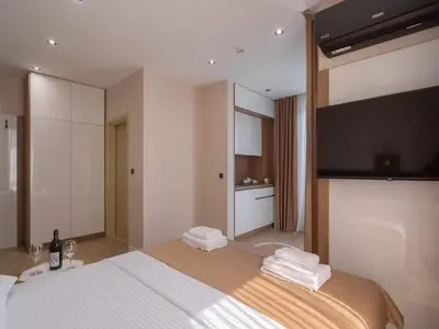 a bedroom with a large bed with towels on it at Hotel Diman in Dobra Voda