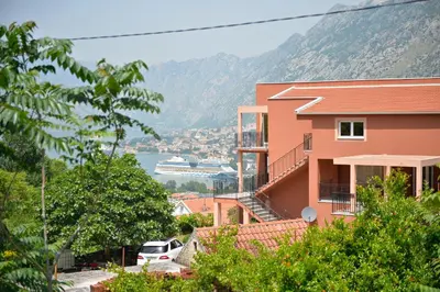 a building with a view of the water and a cruise ship at Apartman Stefan in Kotor
