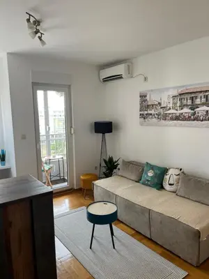 a living room with a couch and a table at Studio Pao in Podgorica