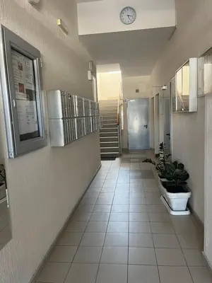 a hallway with a clock on the wall and a staircase at Studio Pao in Podgorica