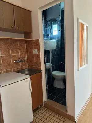 a small bathroom with a toilet and a sink at Apartments Sella in Ulcinj