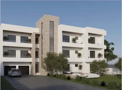 a building with a car parked in front of it at Apartments Sella in Ulcinj