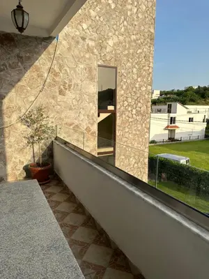 a mirror on the side of a stone wall at Apartments Sella in Ulcinj