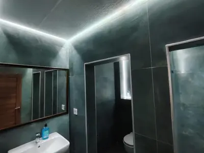 a bathroom with a sink and a mirror and a toilet at Redondo Apartments Budva in Budva