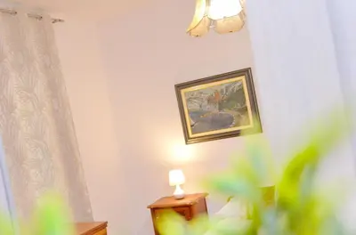 a room with a lamp and a painting on the wall at Central Art Oasis Kotor in Kotor