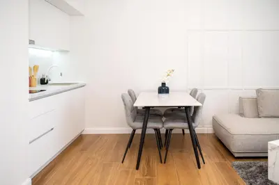 a small kitchen with a table and two chairs at Hotel Teuta in Ulcinj