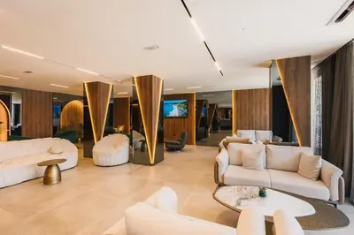 a living room with white furniture and a tv at Hotel Teuta in Ulcinj