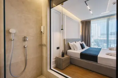 a hotel room with a bed and a shower at Hotel Teuta in Ulcinj