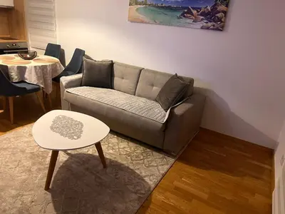 a living room with a couch and a table at Apartman Jakov in Becici