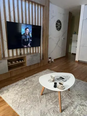 a living room with a tv and a coffee table at Apartman Jakov in Becici