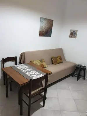 a living room with a couch and a table at Warm & Welcoming Vele Residence in Bar