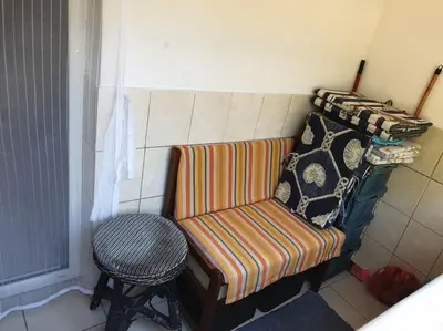 a couch with pillows and a stool in a room at Warm & Welcoming Vele Residence in Bar