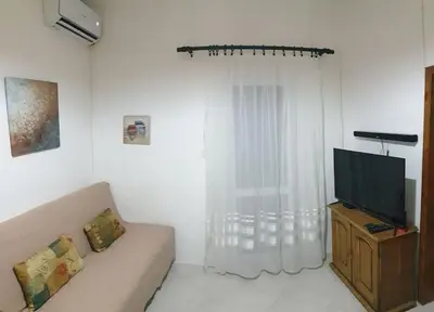 a living room with a couch and a television at Warm & Welcoming Vele Residence in Bar