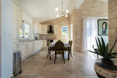 a kitchen with a table and chairs in it at Ventus Rosa Villa in Budva
