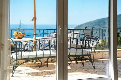 a balcony with a table with a basket of fruit on it at Ventus Rosa Villa in Budva