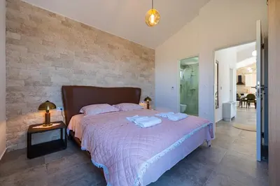 a bedroom with a bed with two towels on it at Ventus Rosa Villa in Budva