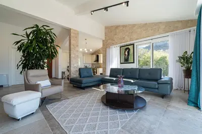 a living room with a couch and a table at Ventus Rosa Villa in Budva