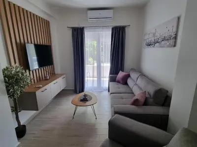 a living room with a couch and a table at Apartment Ninas in Dobrota