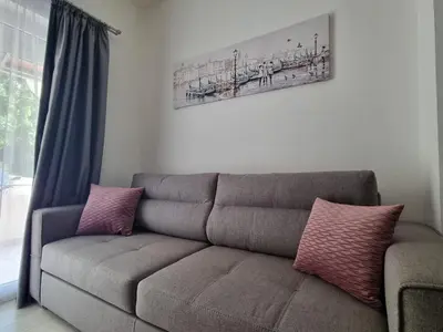 a couch with two pillows sitting in a living room at Apartment Ninas in Dobrota