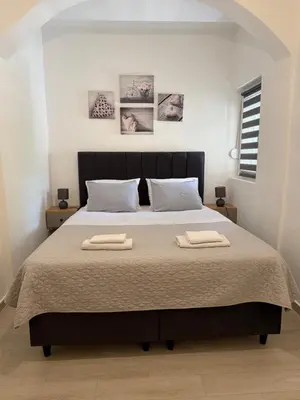 a bedroom with a large bed with two towels on it at Apartment Ninas in Dobrota