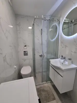a bathroom with a shower and a toilet and a sink at Apartment Ninas in Dobrota