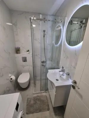 a bathroom with a shower and a toilet and a sink at Apartment Ninas in Dobrota