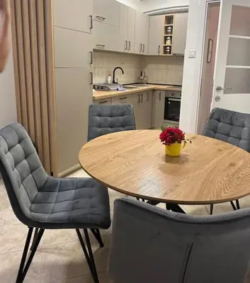 a kitchen with a wooden table with chairs and a tableasteryasteryasteryasteryastery at Apartment Ninas in Dobrota
