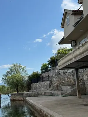 a building next to a body of water at Lake Skadar Paradise in Podgorica